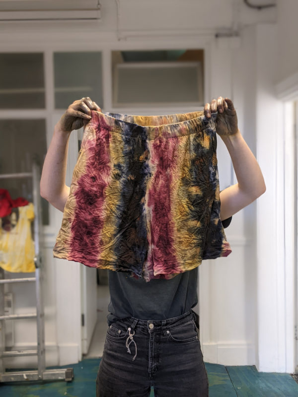 A pair of shorts tie dyed using natural plant dye methods.